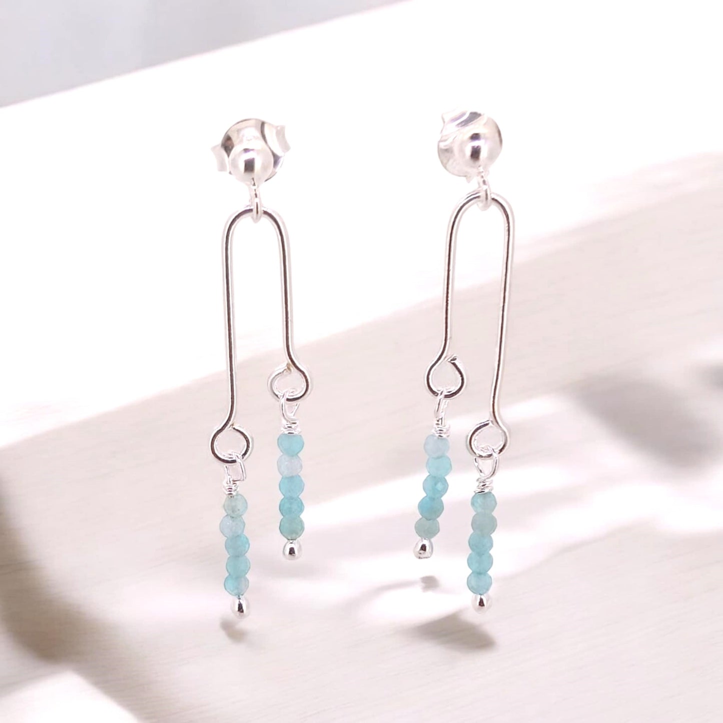 Sterling silver double column stud earrings showcasing a fun design complemented by the beauty of sky blue petite chalcedony gemstones.