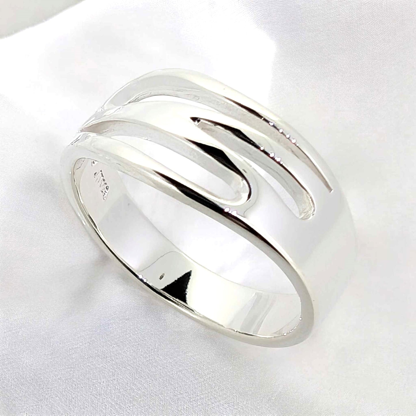 The flowing patterns evoke a sense of movement making this sterling silver ring a dynamic and artistic ring that catches the eye