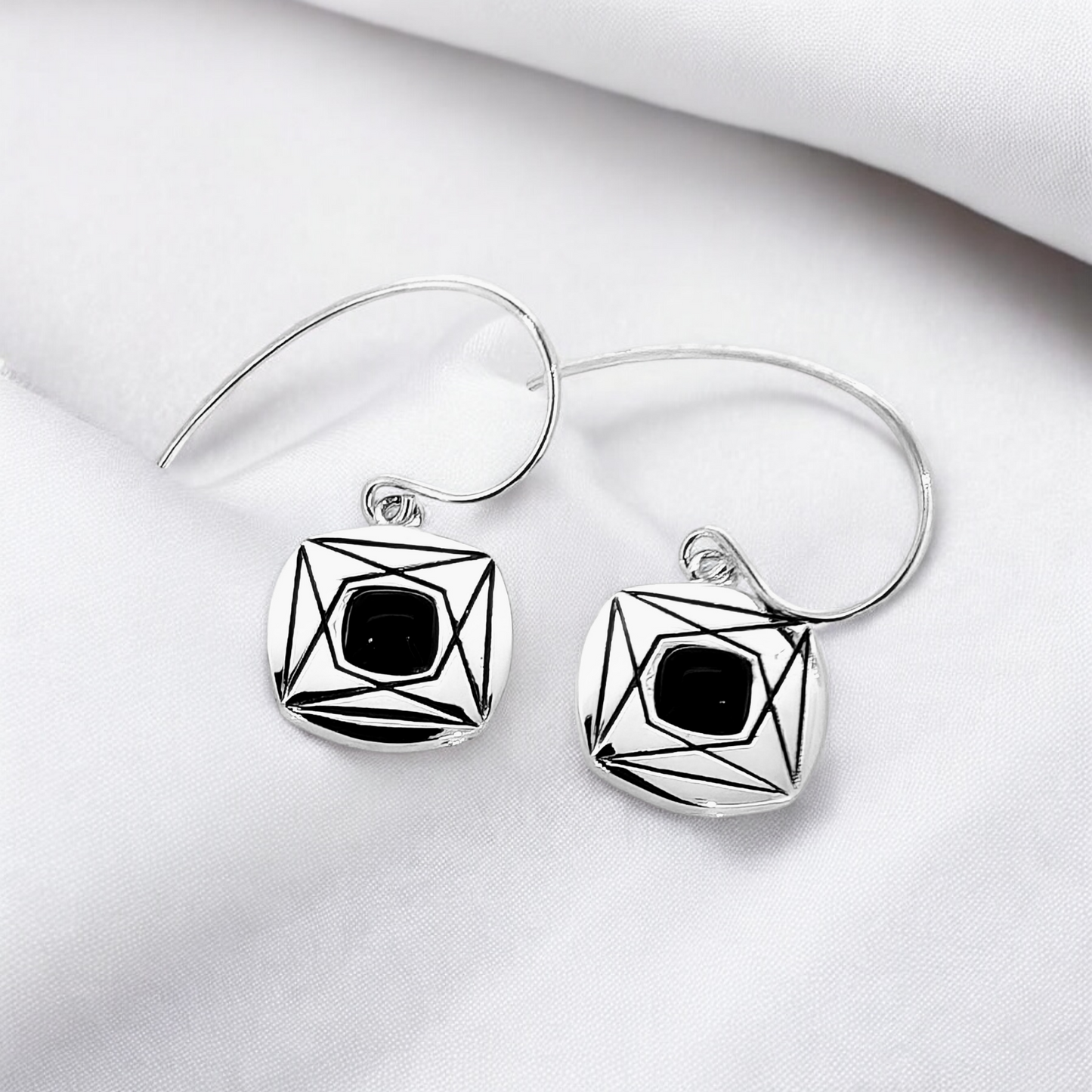 The combination of the sleek silver and the bold onyx makes these earrings a versatile accessory