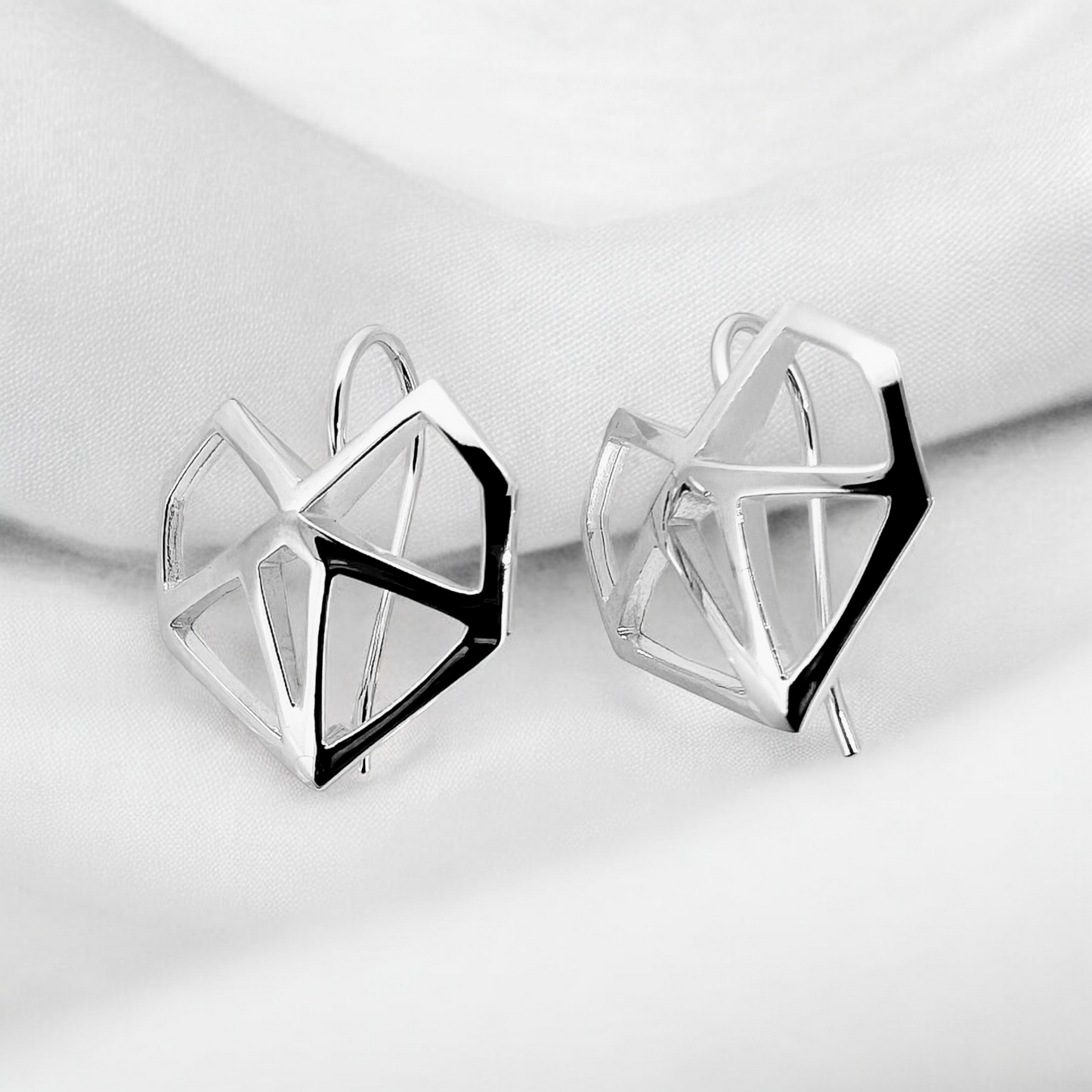 Sterling silver pointed love heart earrings are a modern take on a classic design with each earring exuding playfulness