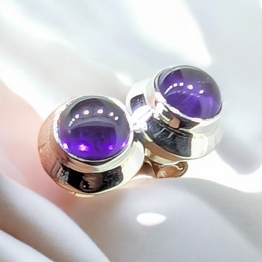 These amethyst stud earrings feature a stunning, deep purple gemstone set in high-quality sterling silver