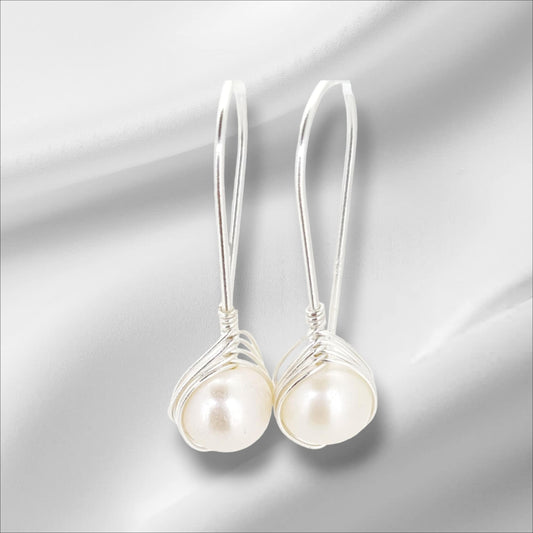 Exquisite Drop Earrings Crafted From Lustrous Freshwater Pearls Cradled In A Nest Of Sterling Silver